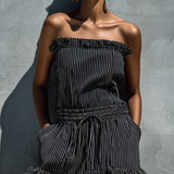 Black and white striped strapless jumpsuit with ruffles